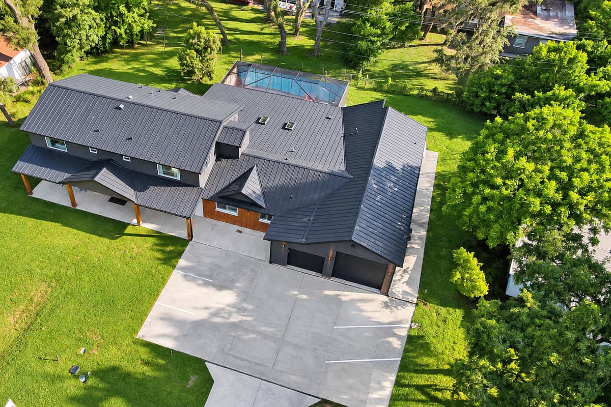 Park six cars and still have a lawn to spare. The full property from above: garages, driveway, house and yard, with room for everyone's vehicles at the same time.