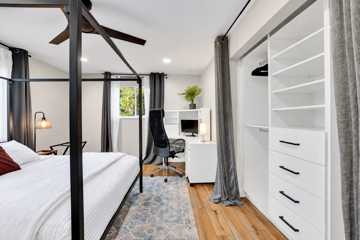 Wardrobe, drawers and a desk of your own. Everything hangs up on the first evening, the laptop has somewhere to live, and the canopy bed handles the rest of the week.