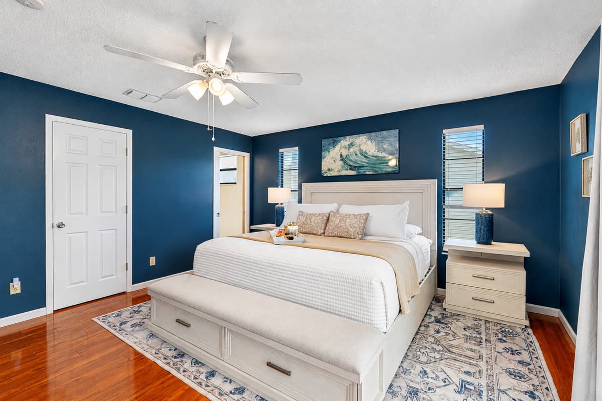 A stylish and serene primary bedroom designed with comfort and class in mind.