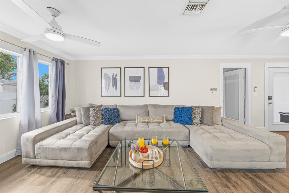 Bright and spacious living room with a large sectional sofa—perfect for relaxing with family and friends.