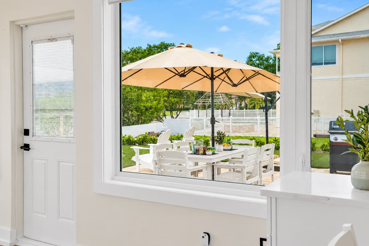 Patio living just outside the door. The door opens straight to the umbrella-shaded patio, dining set and grill. Indoors and outdoors work as one.