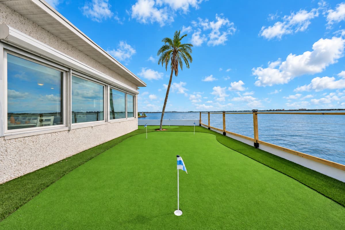 Practice your putt with a bay view. The turf green runs alongside the sunroom with the water on the other side. Golf has never looked this relaxing.