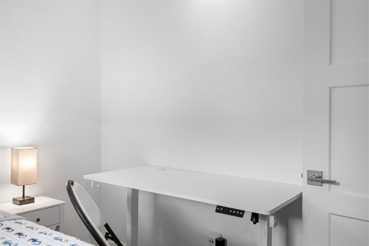 For those who need a space to work or study, This bedroom offers a dedicated area equipped with a sturdy desk and ergonomic chair.