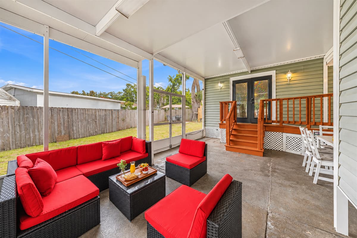 Inviting screened patio with plush seating and easy access to the backyard.