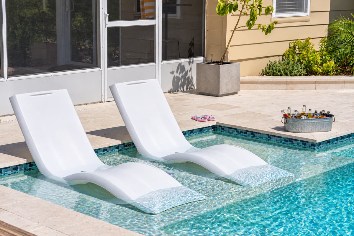 Framed by tropical plants and stylish decor, this pool is the ultimate Instagram-worthy hangout.