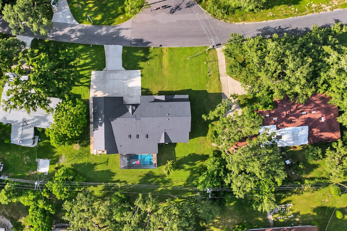 Trees on every side. Neighbors nowhere in sight. A deep, wooded lot that keeps the pool, the lanai and the lawn genuinely private from the first day to the last.