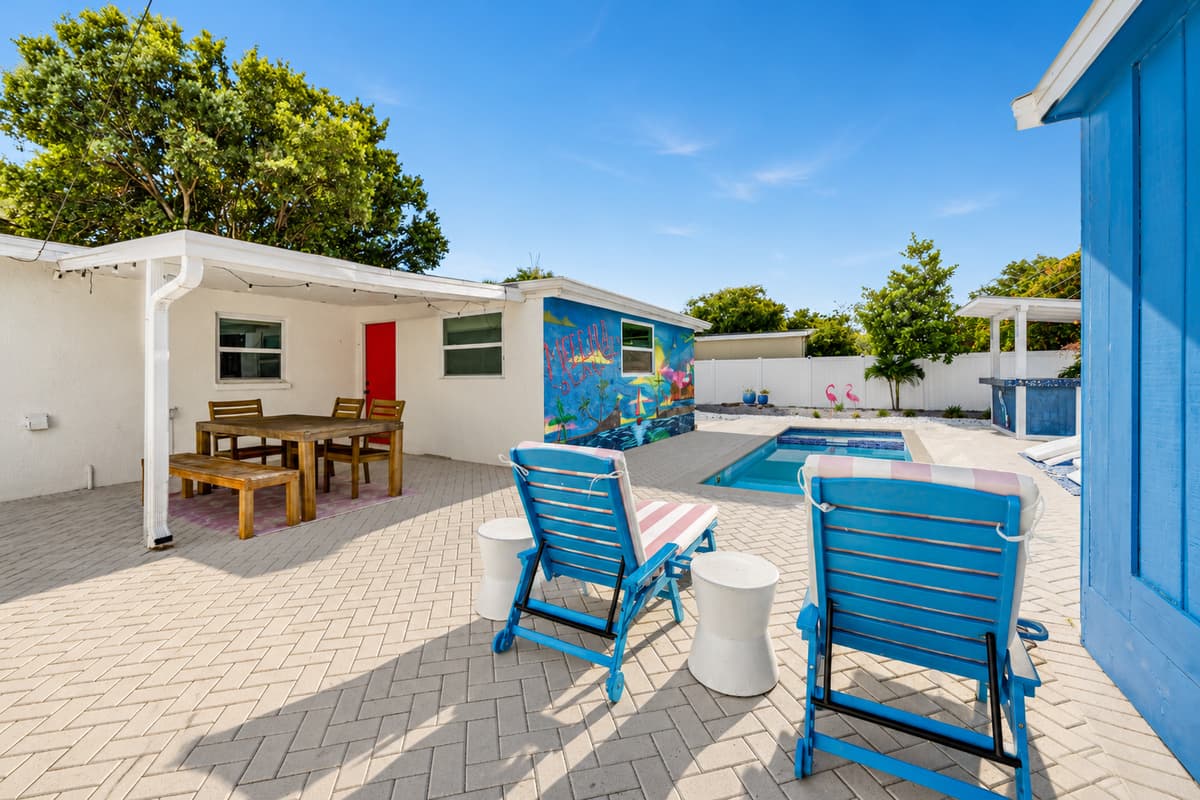 Comfortable outdoor seating area adjacent to the pool, offering additional space for relaxing and socializing.