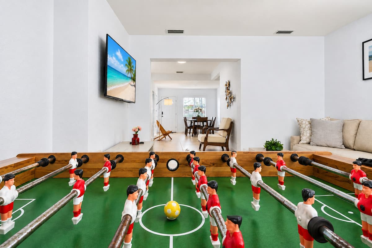Entertainment room with foosball table, smart TV, and spacious open-concept layout.