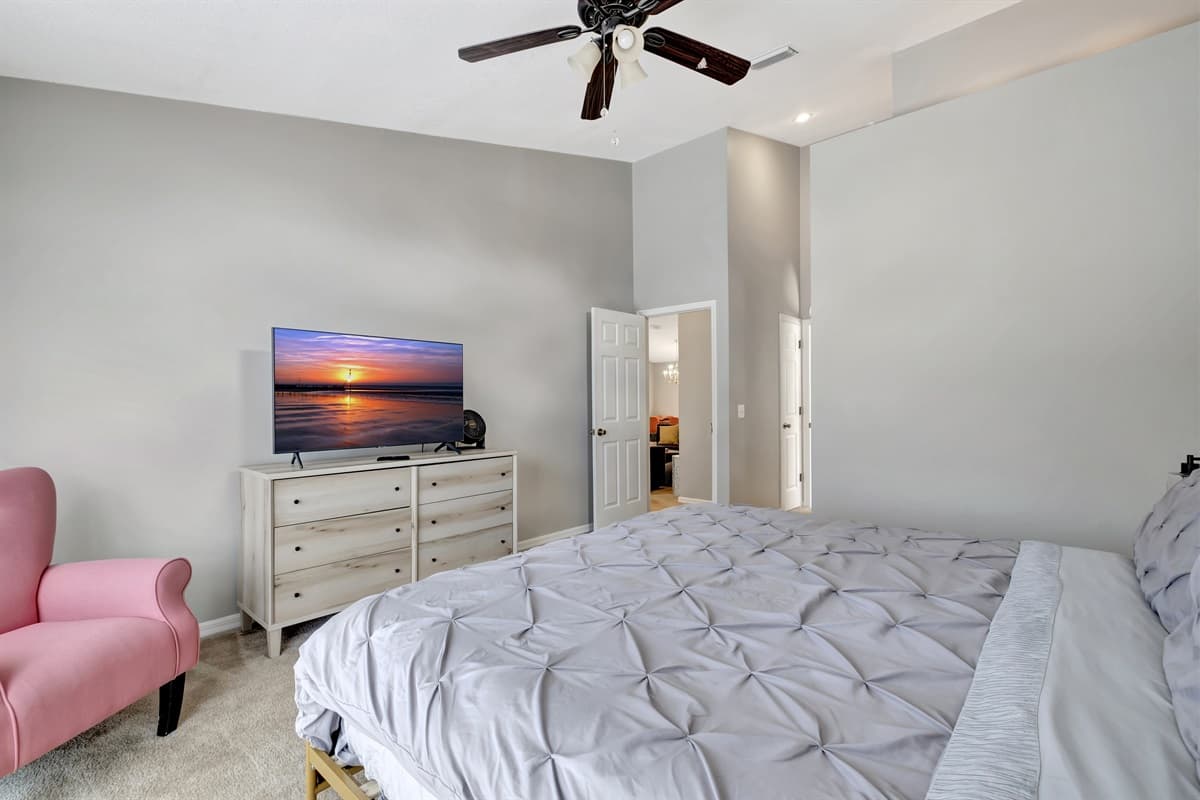 This stunning bedroom features a king sized bed and with its expansive windows not only flood the room with natural light but also offer panoramic views of the surroundings.