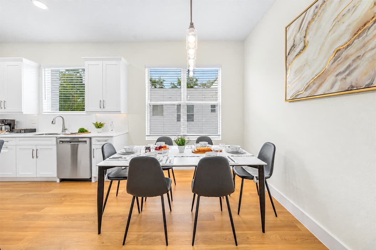 Bright dining area with modern finishes and easy access to kitchen.