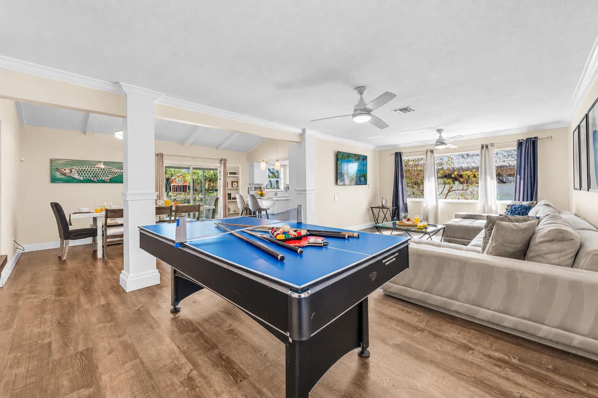 Open floor plan connects the game room, dining area, and living room for easy gathering.