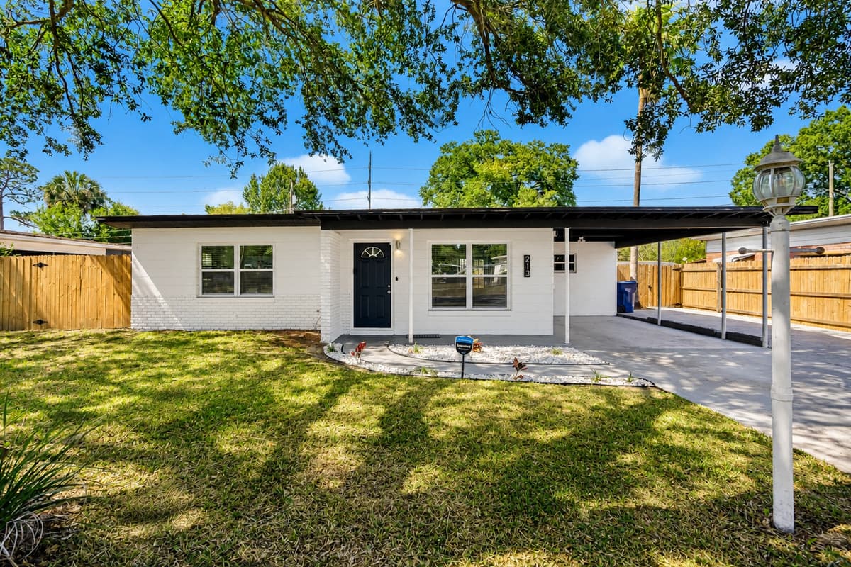 As you pull up to the front of the property, you'll be greeted by a lush green lawn and a spacious driveway.