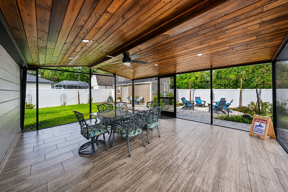 Expansive screened-in patio with large outdoor dining space perfect for entertaining, relaxing, and enjoying Florida evenings.