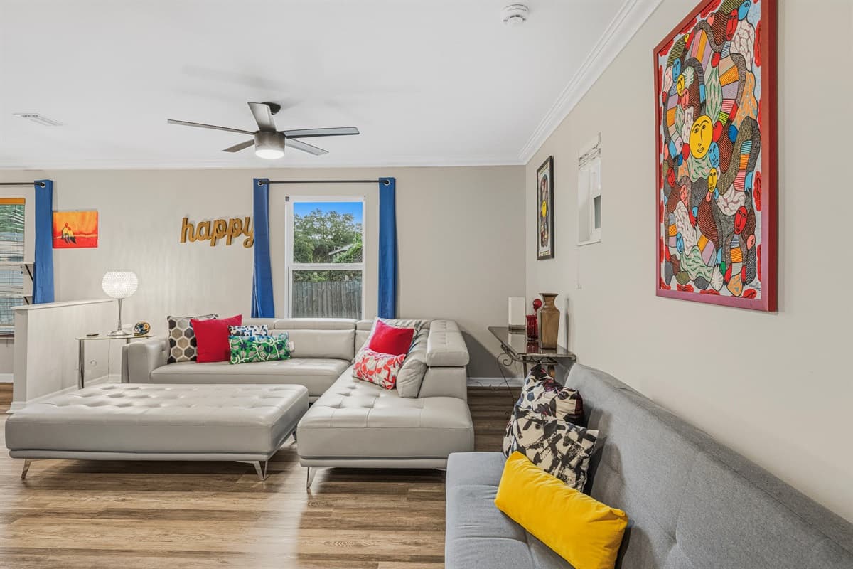 Alternate view of the living space highlighting natural light, modern decor, and roomy layout.