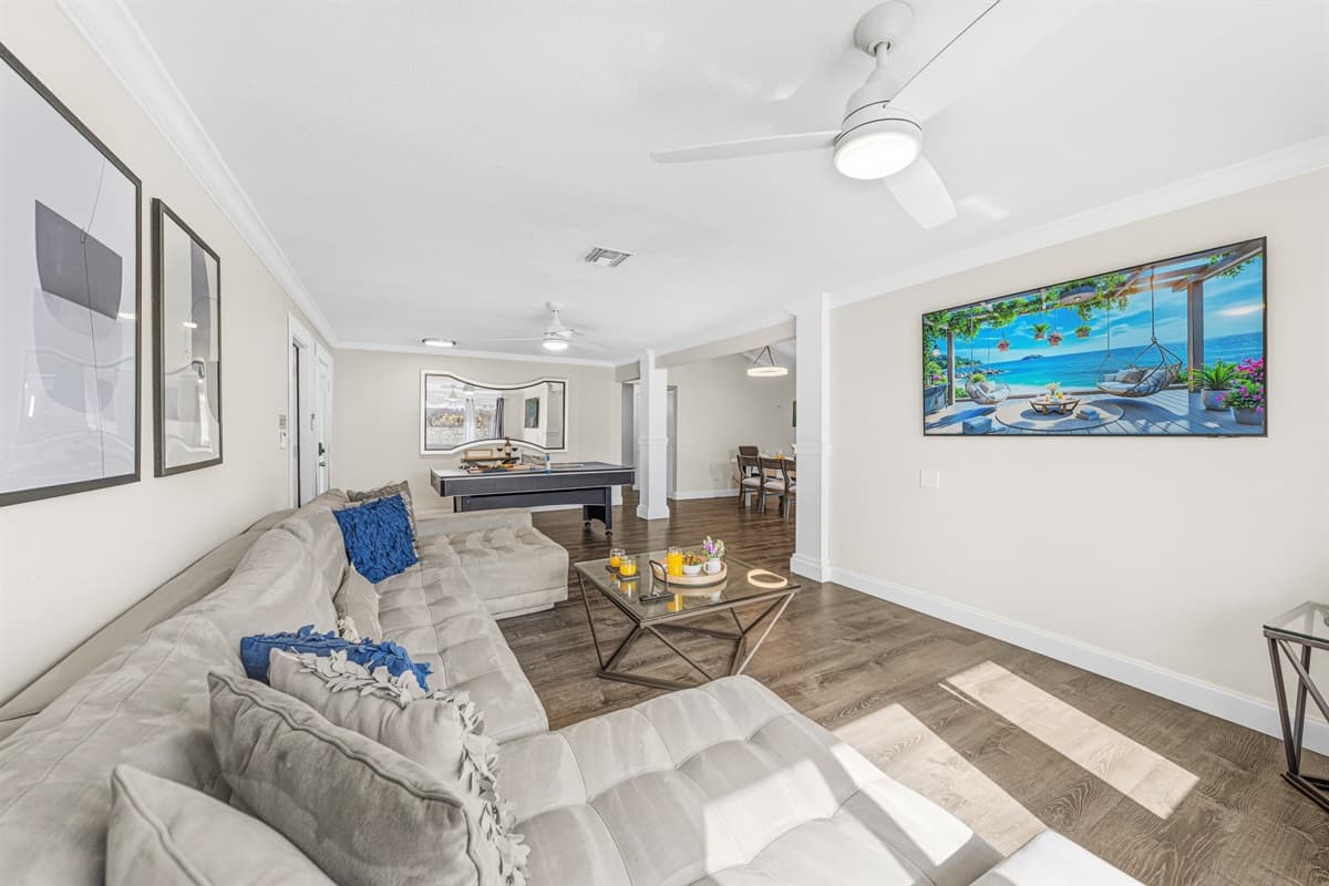 Open-concept living area featuring comfortable seating, a Smart TV, and plenty of natural light.
