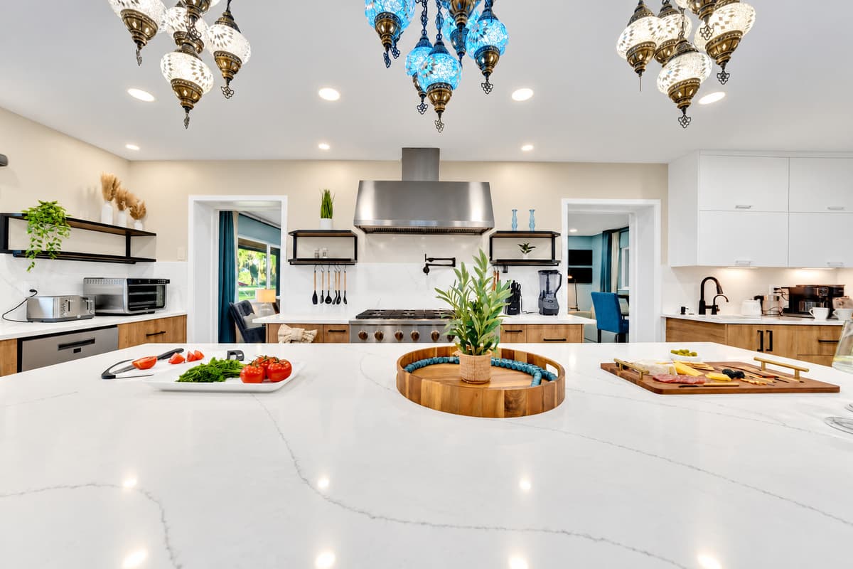 Two islands, so nobody works in anyone's way. Prep on one, serve on the other, seat the crowd around both — the layout that turns cooking for a large group into part of the party.