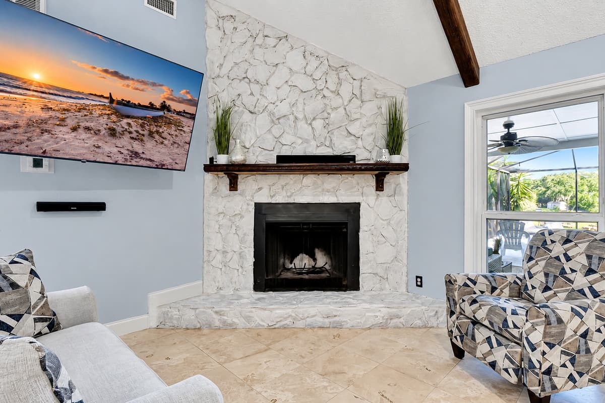 Plush couch beckons and the gentle glow of a fireplace sets the perfect ambiance.