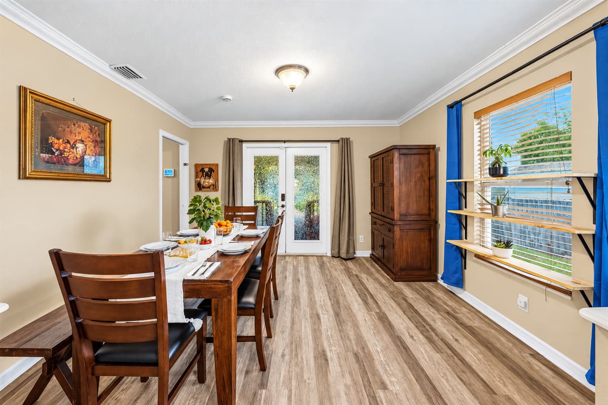 Bright dining room with natural light and backyard views—perfect for relaxed dining experiences.