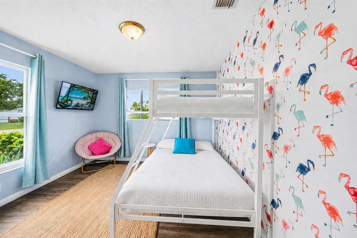 Spacious view of Bedroom 4 showcasing vibrant wall accents and flexible sleeping arrangements.