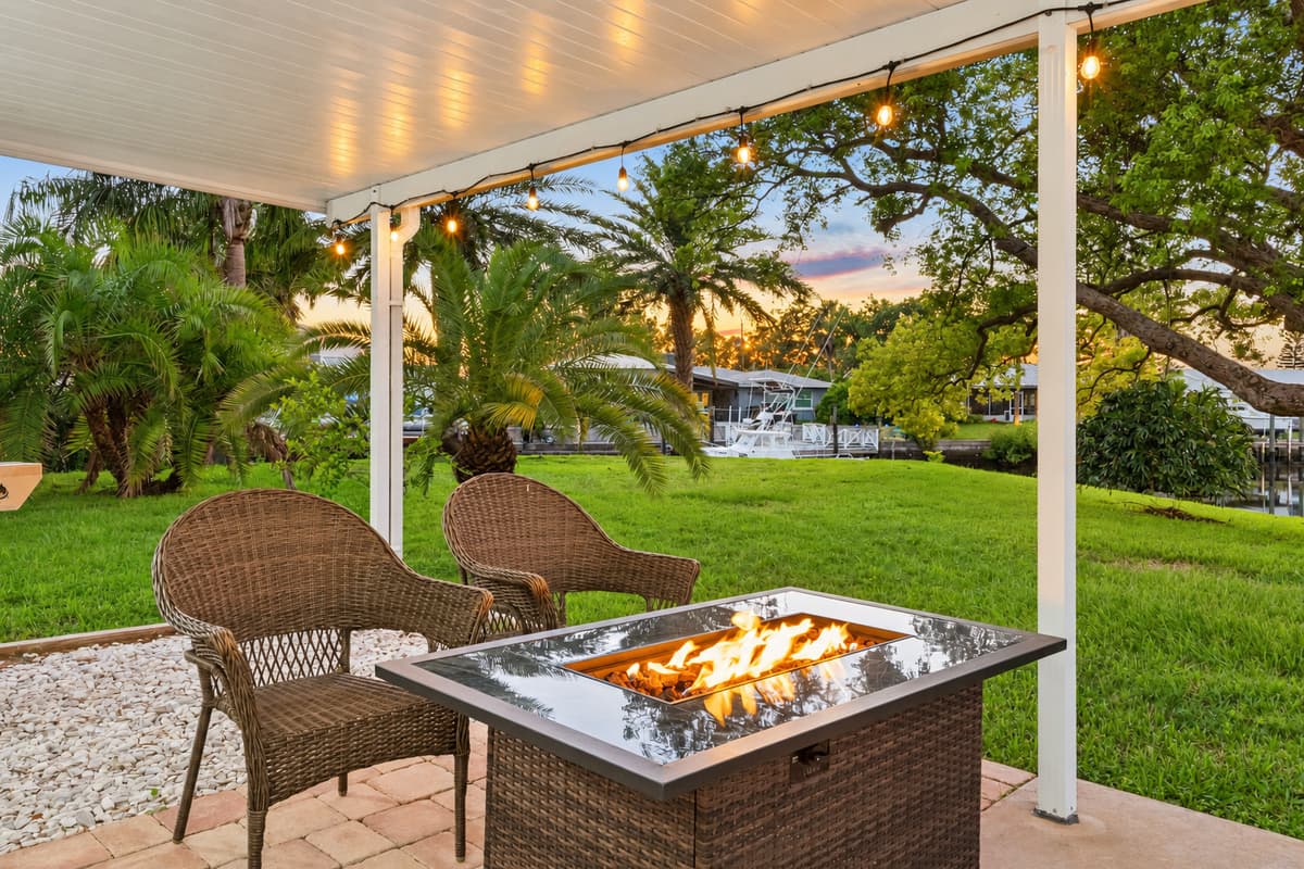 A modern fire pit anchors the seating area, offering warmth and a focal point for evening conversations under the stars.