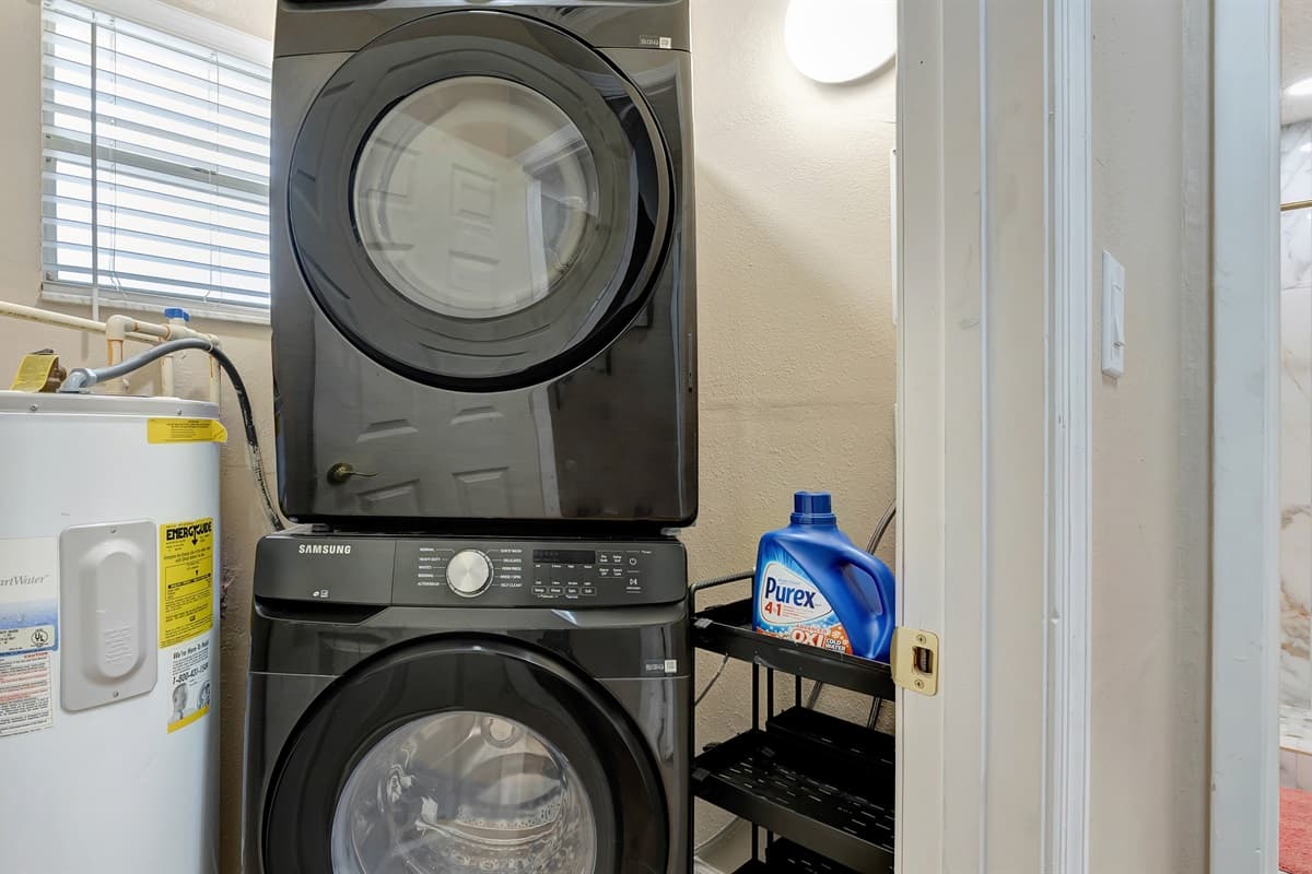 The laundry area boasts a modern washer and dryer, accompanied by a comprehensive selection of laundry supplies to make your chores a breeze.