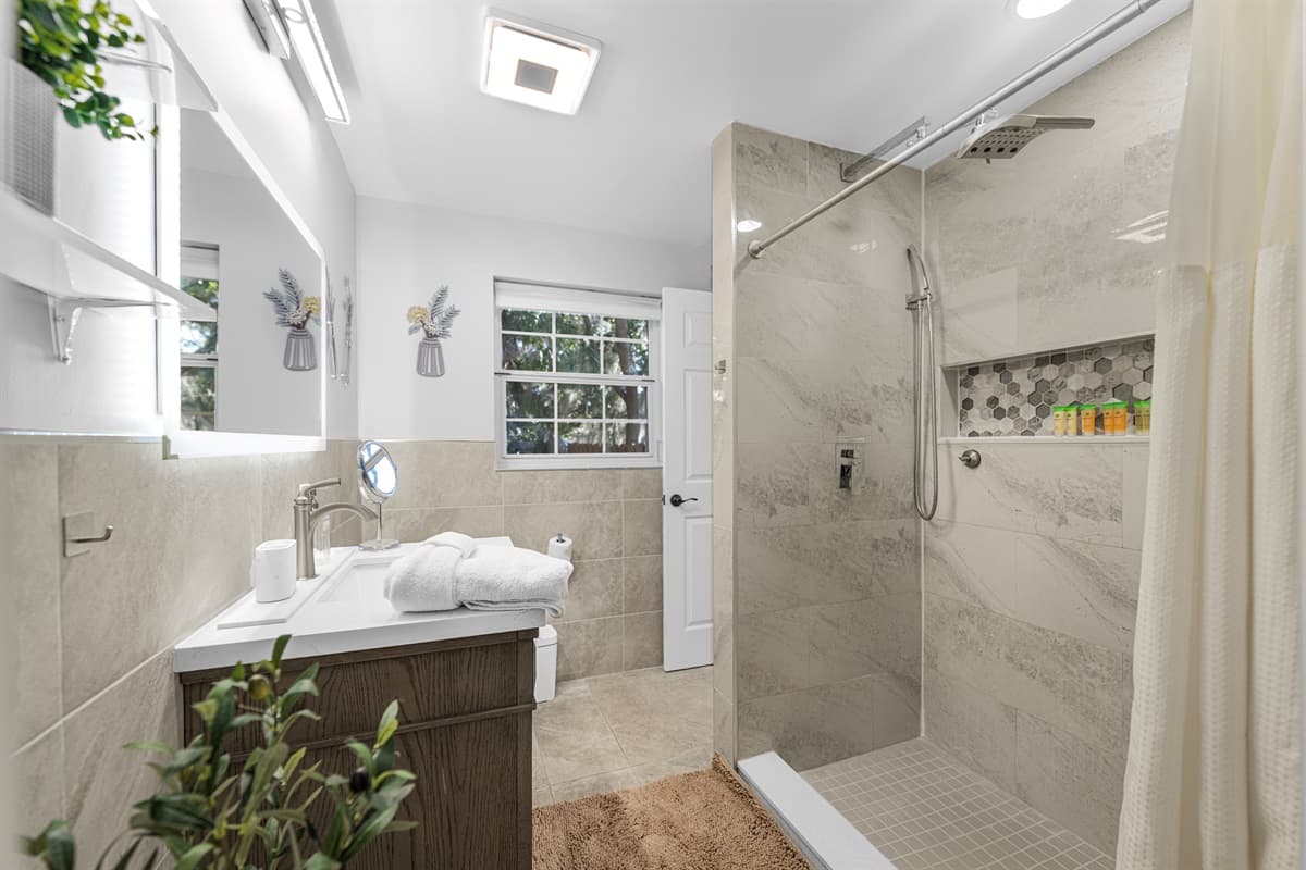 A serene bathroom retreat featuring neutral tones, elegant finishes, and a bright, airy layout.