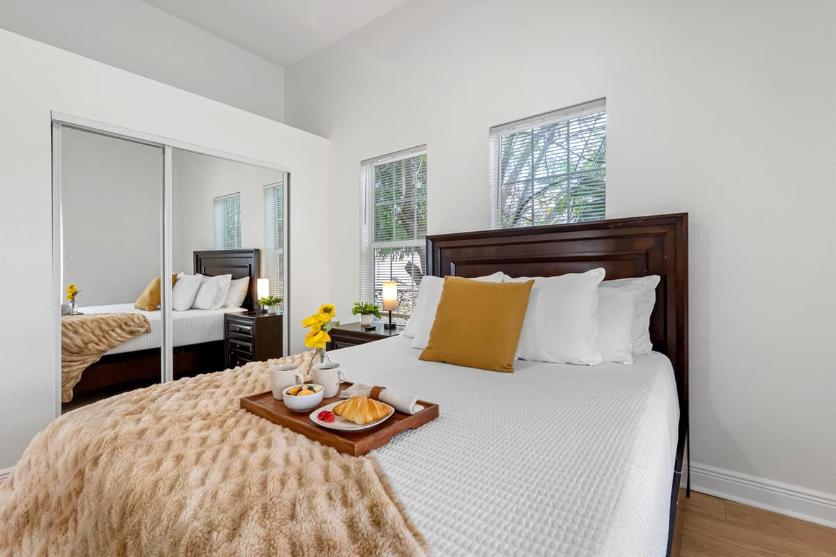 Relax in this beautifully appointed bedroom with plush bedding, tasteful accents, and a bright, airy atmosphere.
