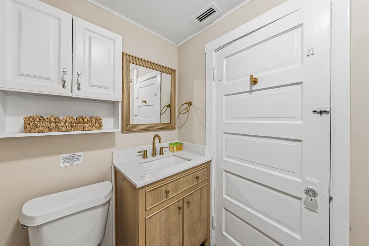Bathroom with modern sink, storage, and updated fixtures.