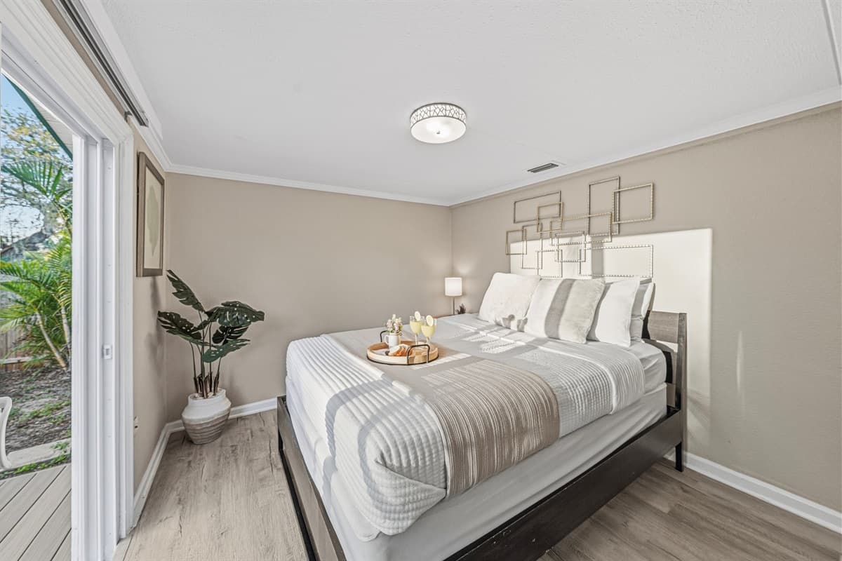 Bright bedroom with modern décor and cozy, inviting bedding.