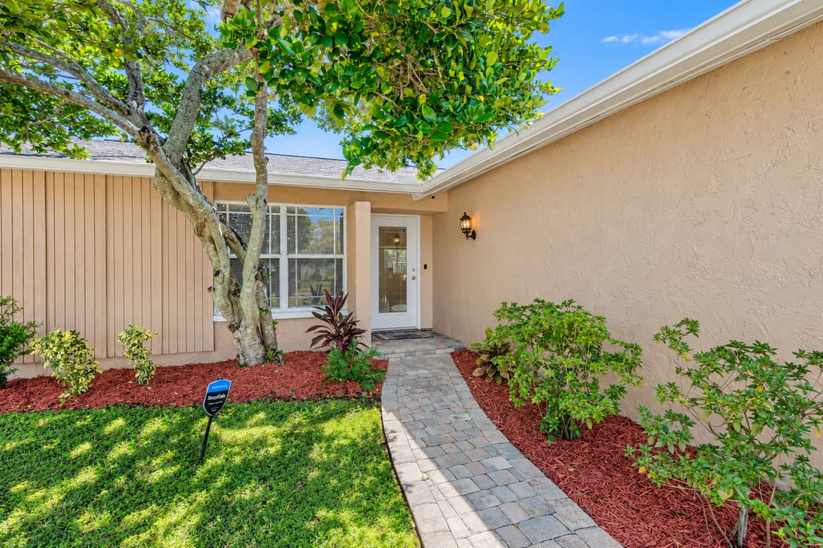 This entryway will welcome you and make you feel at home once you reach the property that has beautiful plants and a well maintained lawn. If you like what you see, send us an inquiry!