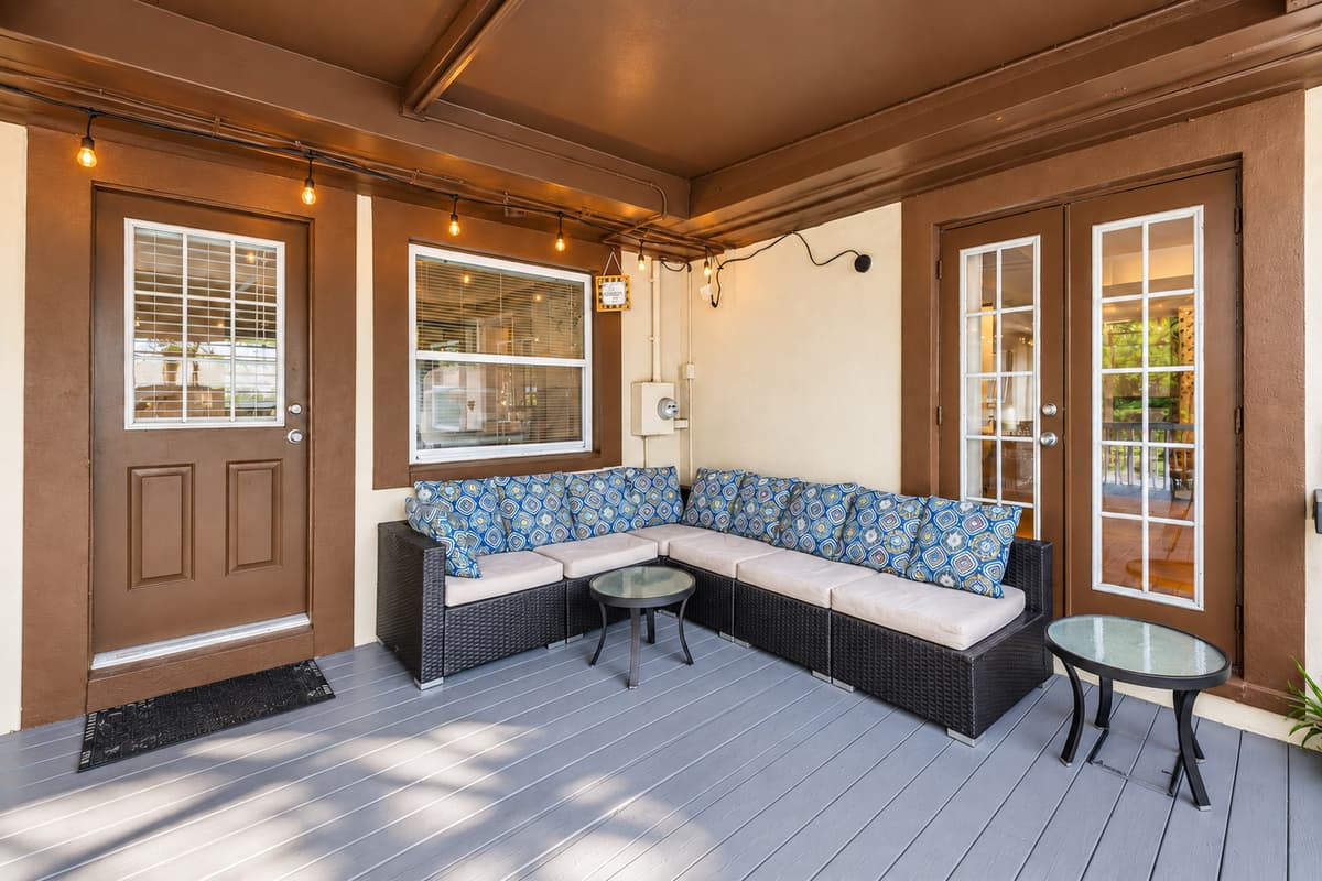 Comfortable outdoor lounge area featuring cushioned seating and ambient string lighting.