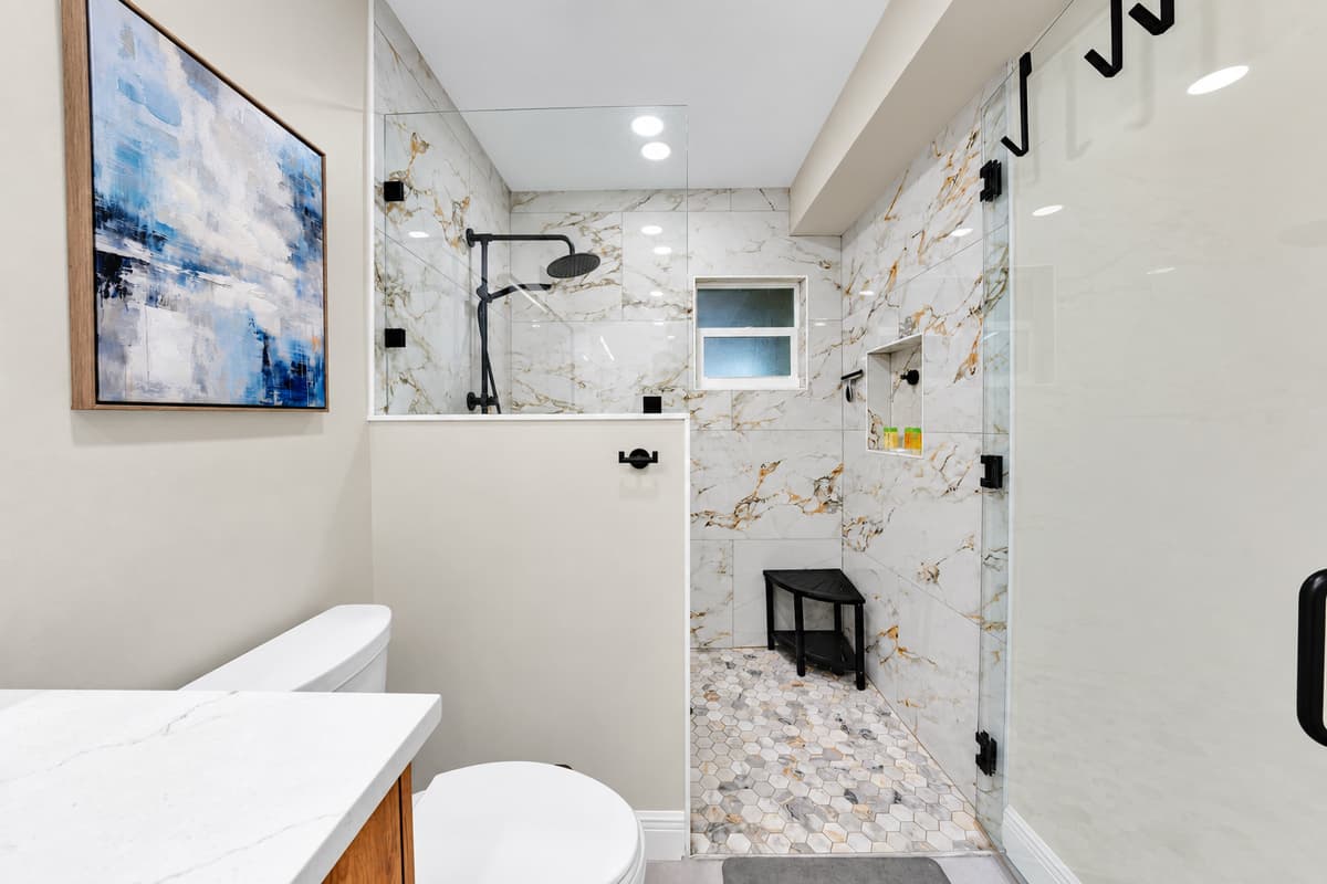 Marble walls, glass shower, and no one knocking. Another full bathroom in a house with seven and a half — private, bright and steps from where you're sleeping.