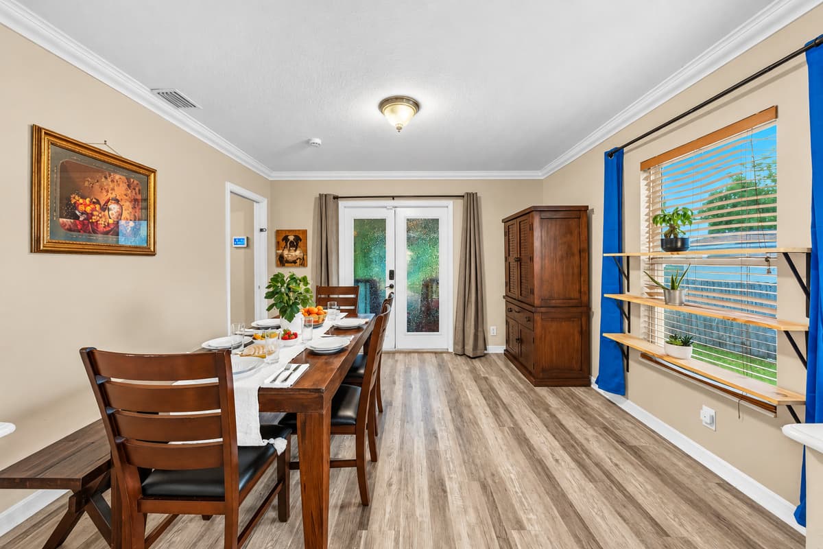 Bright dining room with natural light and backyard views—perfect for relaxed dining experiences.