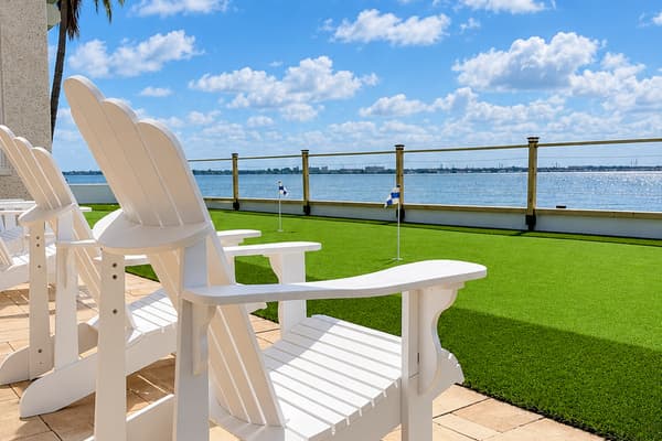 Waterfront patio with outdoor dining and places to relax.