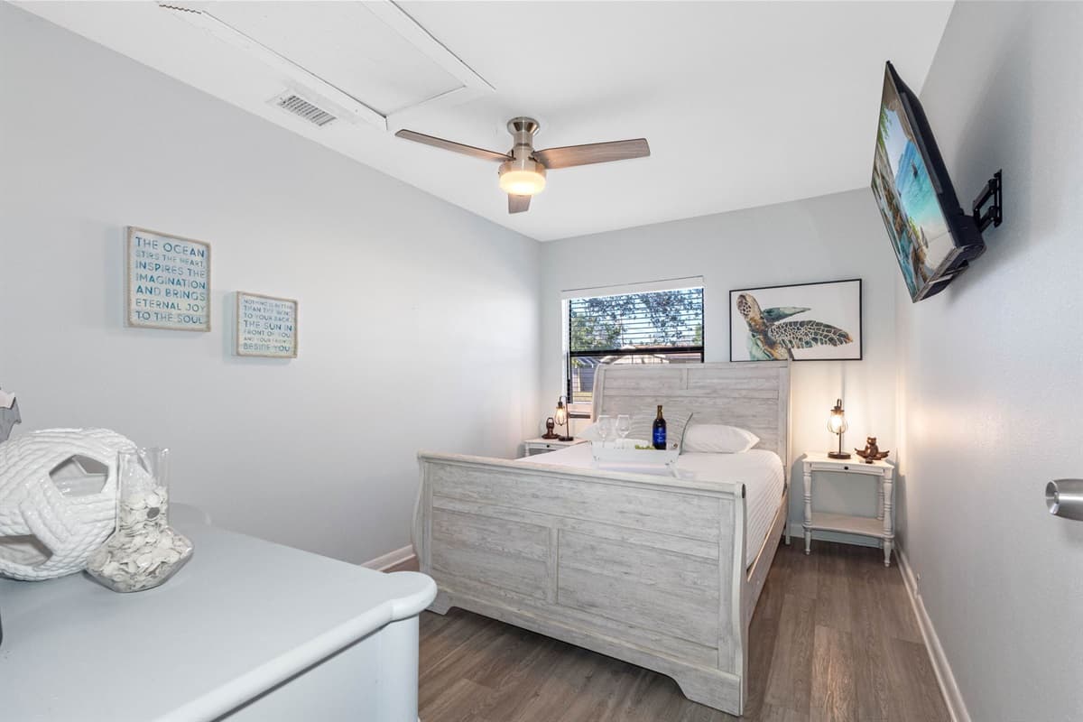 This bedroom features a plush queen-size bed, dressed in soft, high-quality linens, ensuring a restful night's sleep for up to two guests.
