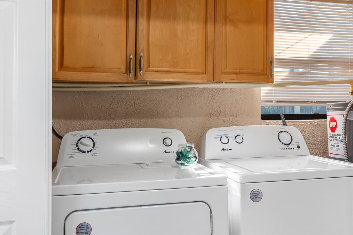 This home includes a full laundry area complete with a washer, dryer, and essential laundry supplies.