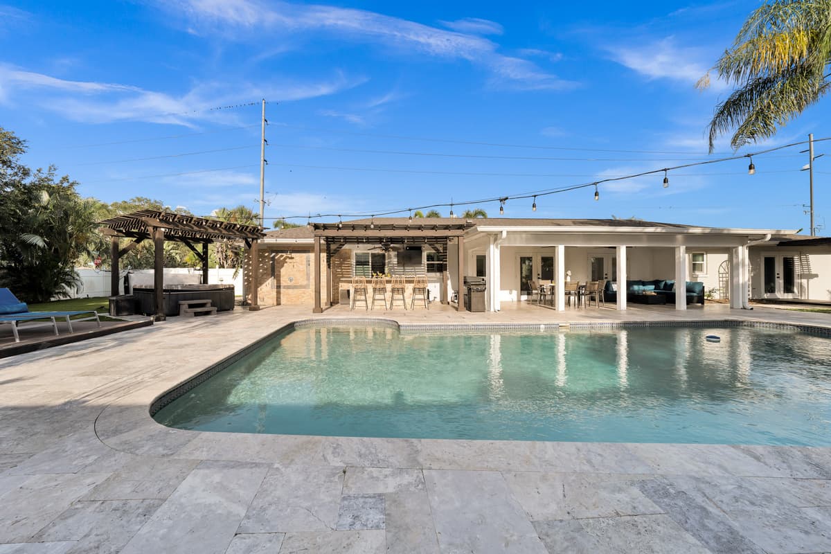 From hot tub to bar to covered lanai, this single frame shows just how much resort-style living this backyard delivers