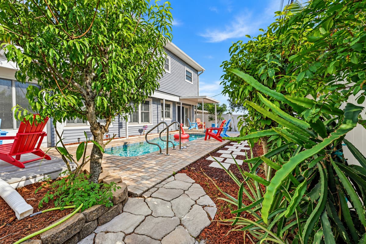 Lush landscaping and stone pathway surrounding the home—enhancing the outdoor experience 