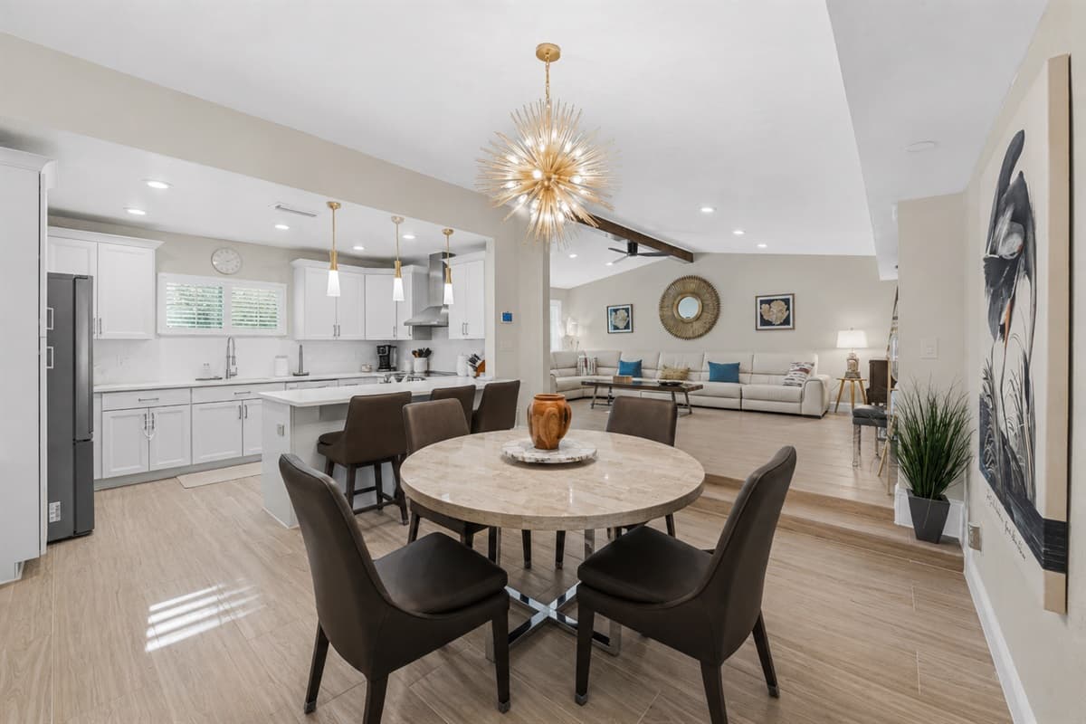 Modern open living space seamlessly connecting the dining area and fully equipped designer kitchen.