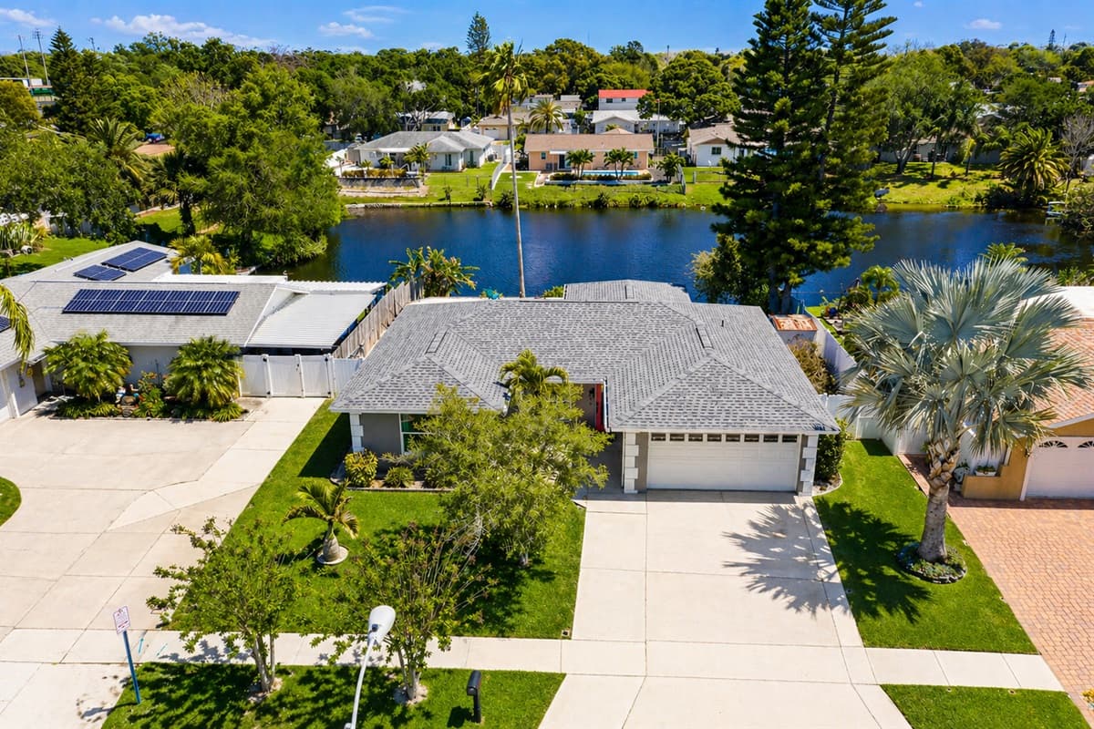 Aerial view highlighting the home’s location near the water and surrounding neighborhood.