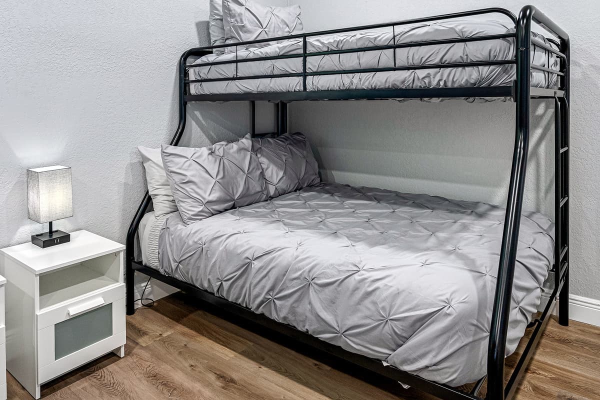 Two single over double bunkbeds for a small family or a group of friends who wants to hang out and sleep in one room. It is very spacious and has its own TV. If you are interested to book this house, Send us a message now!