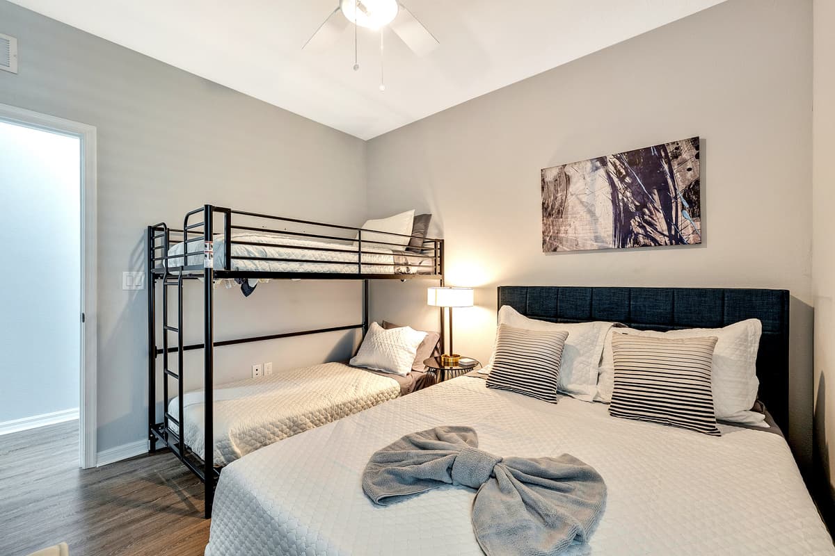 Adding an element of playful charm and practicality, the room features a captivating bunk bed, cleverly designed to accommodate a variety of needs.