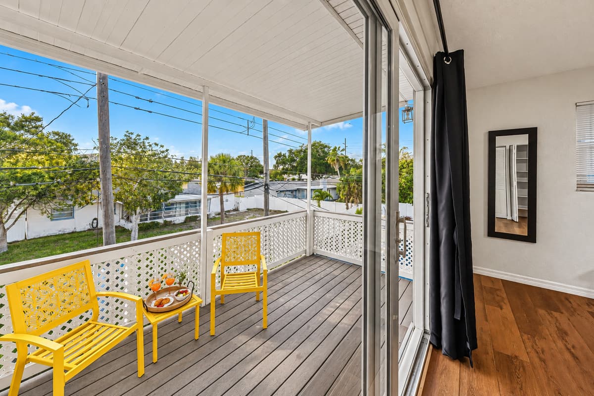 Private balcony with comfortable seating and peaceful neighborhood views—ideal for morning coffee 
Food and drinks shown are for staging purposes only and are not included.