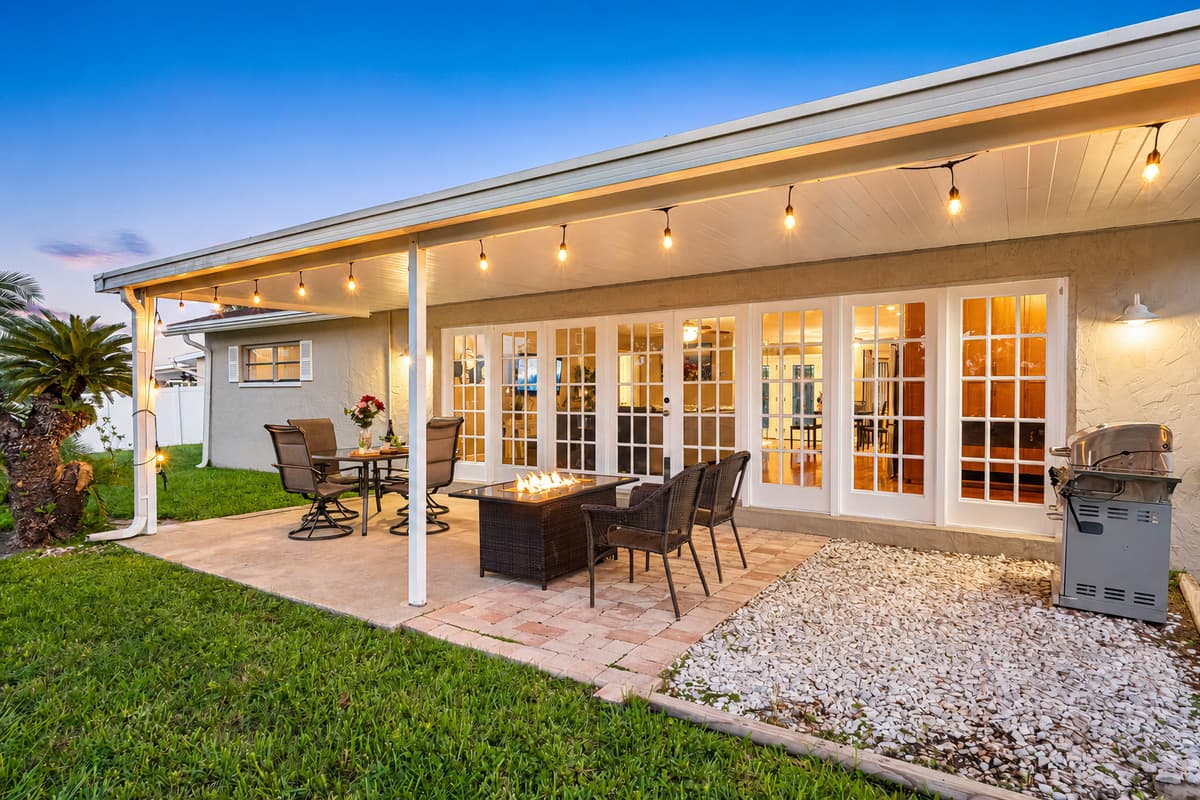 With a spacious dining set and cozy seating around a fire pit, this outdoor area is designed for effortless entertaining and memorable gatherings.