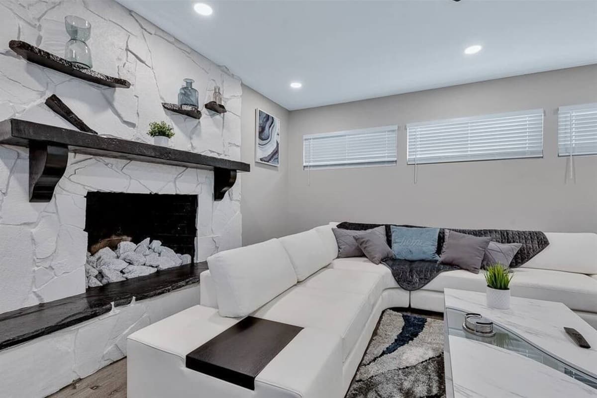 Feel cozy and comfortable while relaxing in our beautiful living room with a magnificent fireplace, L-shaped modern couch and smart TV. If you are interested in this property, send us an inquiry right away!