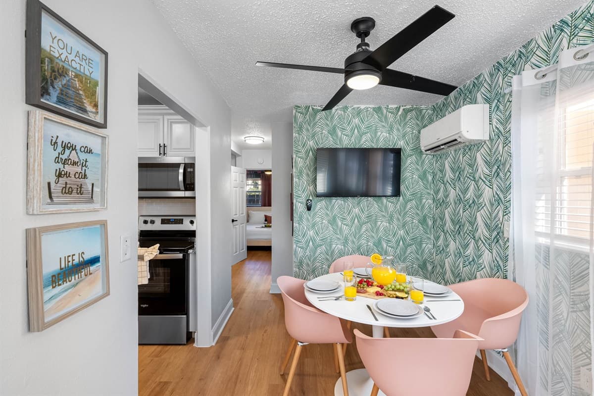 A comfortable dining table beckons, offering a spot for beachside feasts and memorable moments.