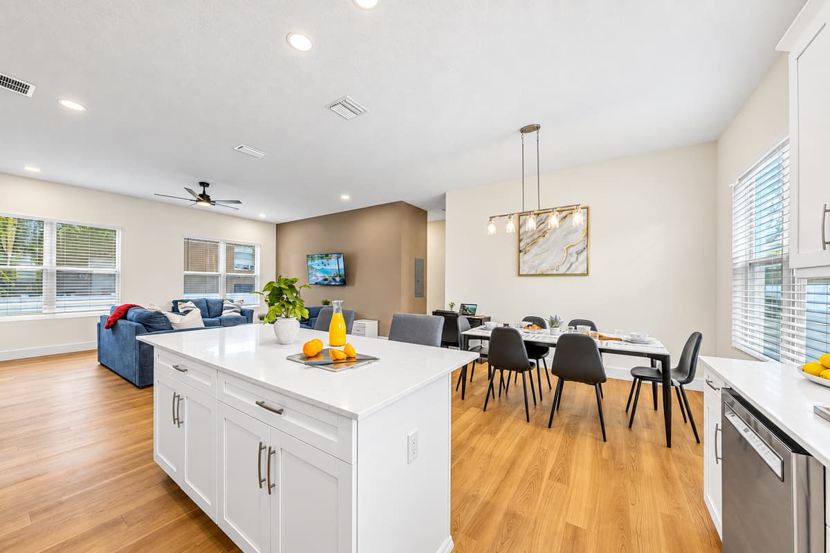 Wide view of kitchen and dining area highlighting the open, airy layout.