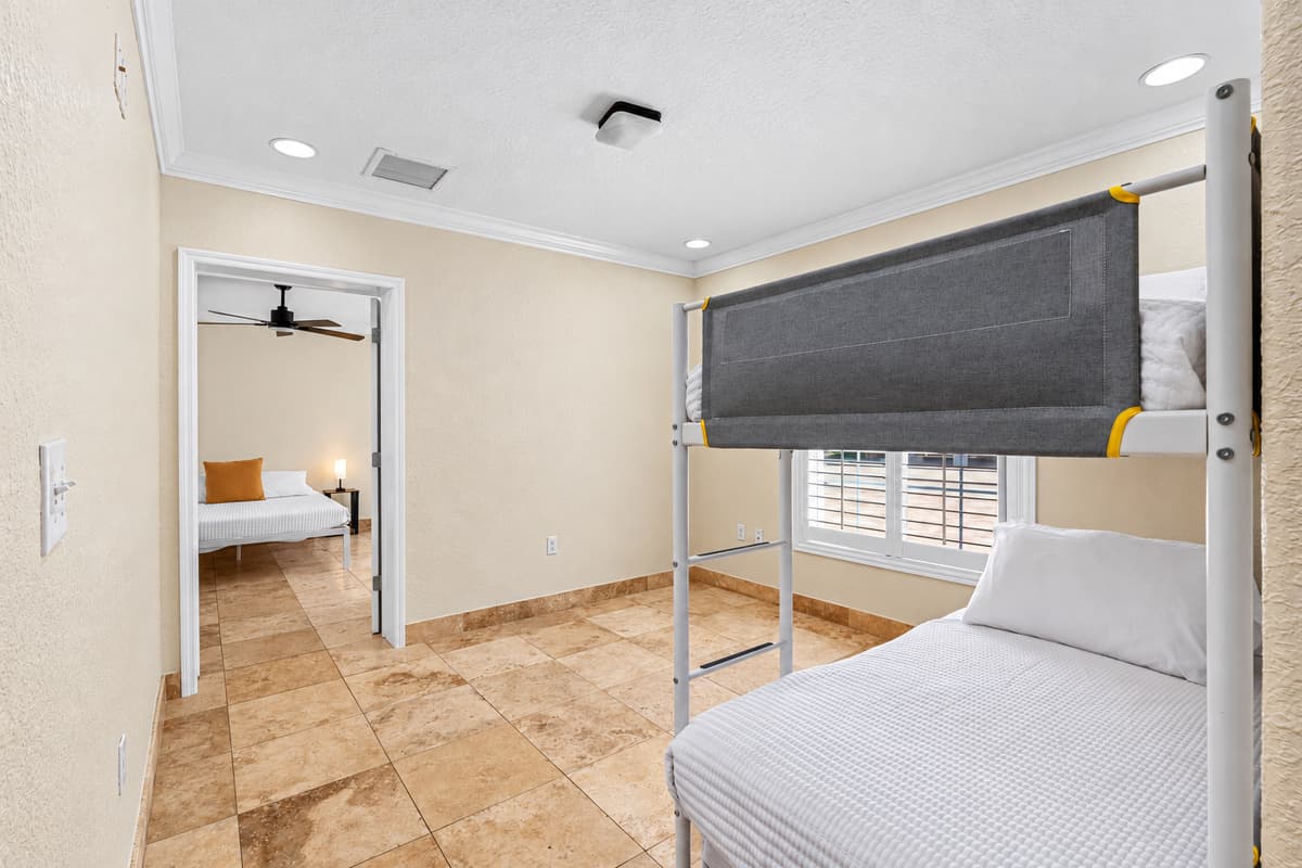 Featuring a sturdy bunk bed frame and fresh bedding, this room maximizes sleeping space without sacrificing style.