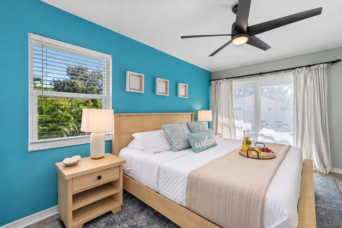 The elegant king bedroom offers a relaxing space with modern decor, a private ensuite, and plenty of natural light.