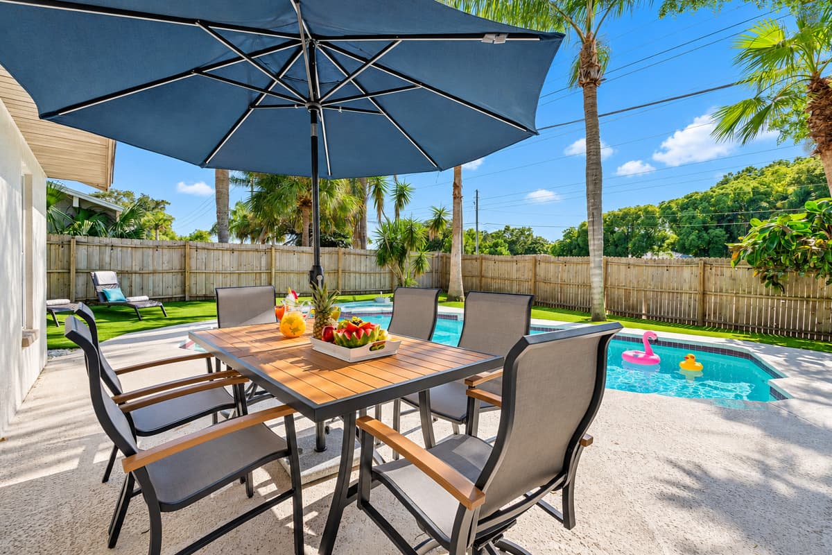 Nestled beside the shimmering waters of the pool, the dining space invites you to savor every bite while enjoying the soothing ambiance of gently rippling water and the soft glow of nearby landscape lighting.